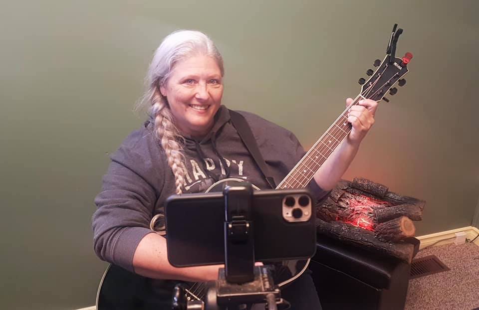 Leah playing guitar for Folk Music Ontario Campfire Song Swap